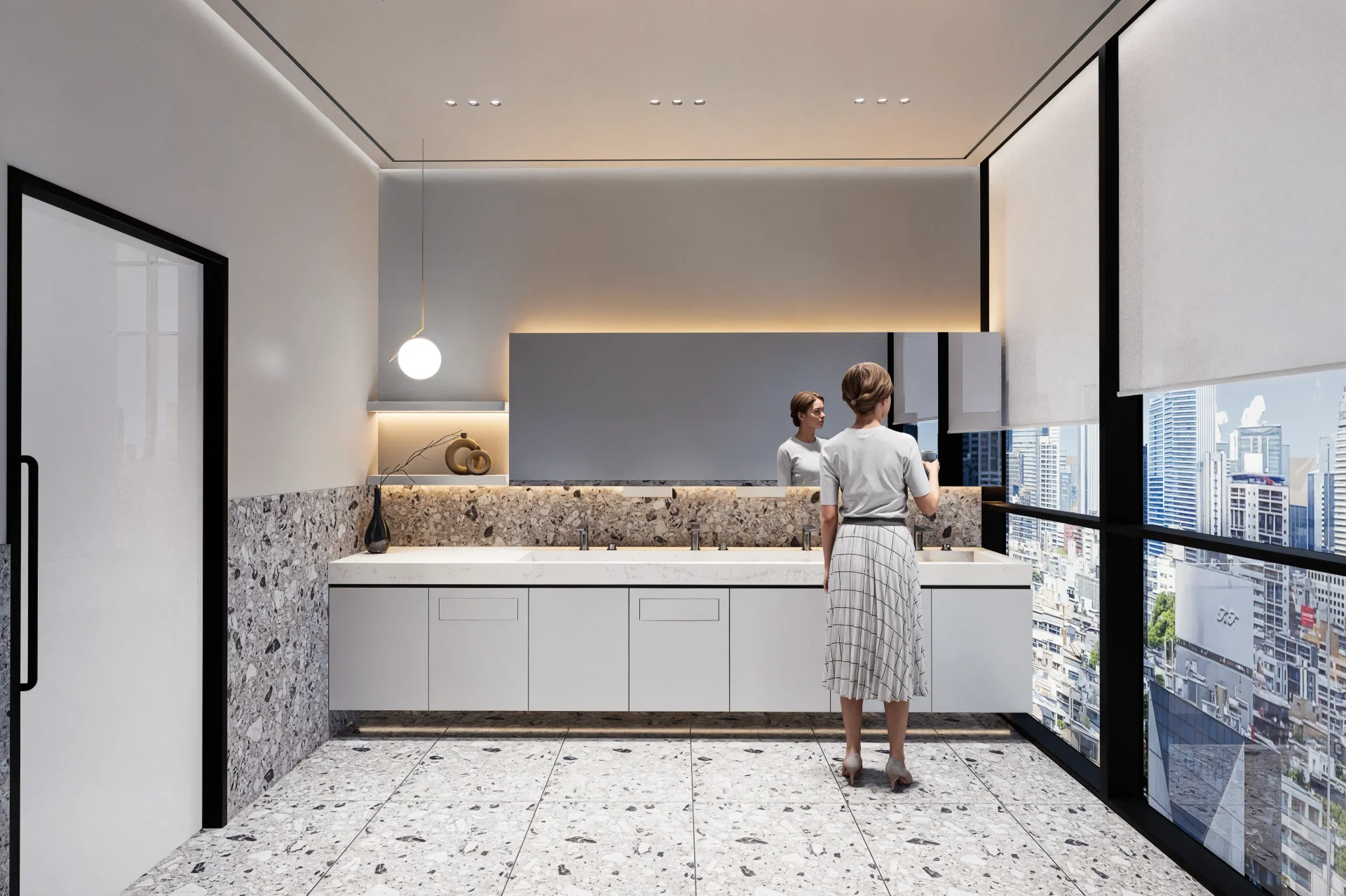 현대적인 오피스 인테리어의 치카치카룸(양치 공간)으로, 넓은 세면대와 깔끔한 화이트 캐비닛이 설치된 모습입니다. 두 명의 여성이 세면대 앞에 서 있으며, 벽면은 회색 대리석과 화이트 컬러로 마감되어 있습니다. 바닥과 벽면 하단부는 테라조 패턴의 타일로 장식되어 있고, 천장에는 심플한 펜던트 조명이 설치되어 있습니다. 오른쪽 창문을 통해 도시 전경이 보이며, 전체적으로 밝고 깨끗한 분위기의 사무실 위생 공간 디자인을 보여줍니다.