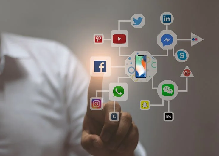 Person interacting with social media network icons on screen