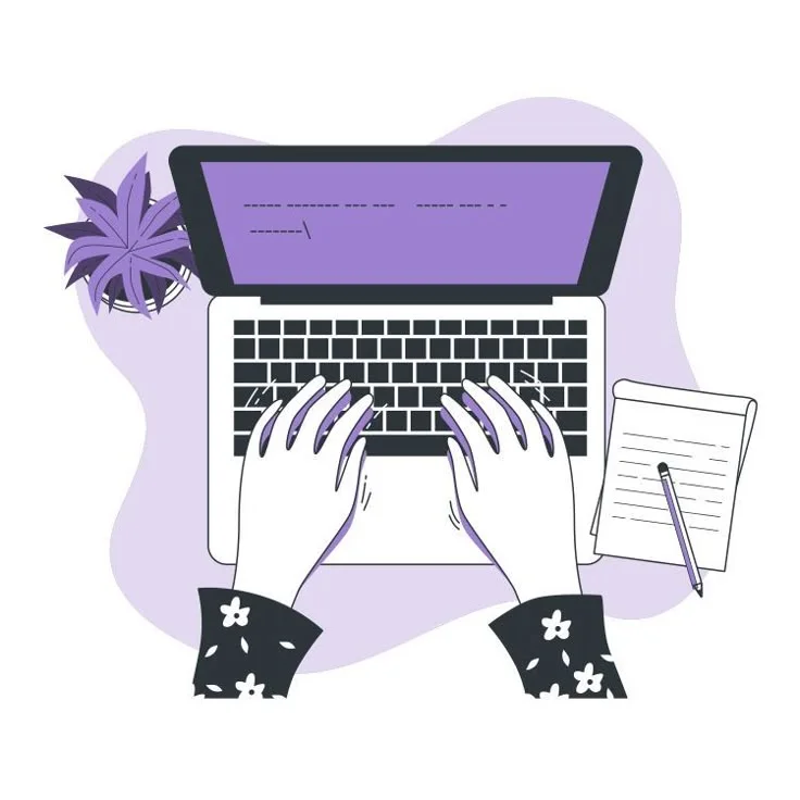 Typing on computer with notepad and workspace setup