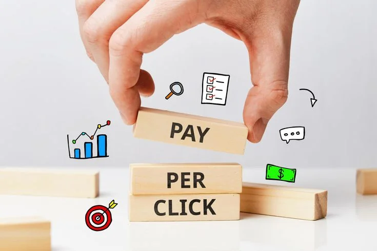 Hand arranging pay per click blocks with analytics icons