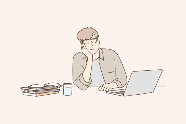 Tired man staring at laptop feeling bored and unmotivated