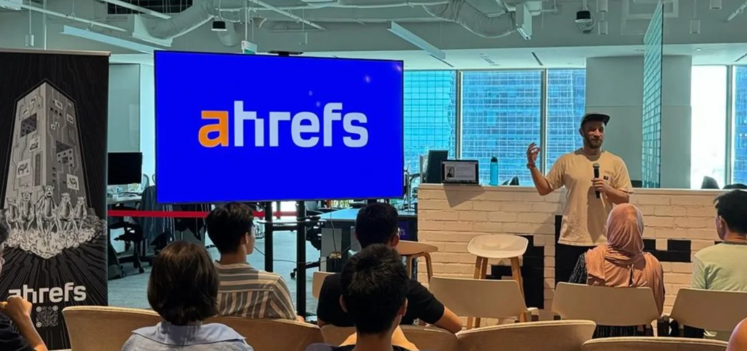 Ahrefs team town hall with speaker presenting in front of employees