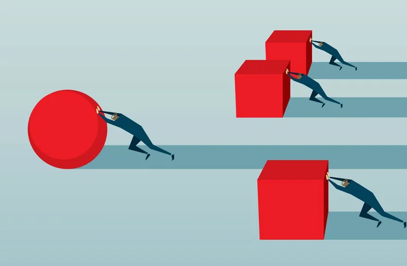 people pushing shapes—one struggling with a cube, the other efficiently rolling a sphere