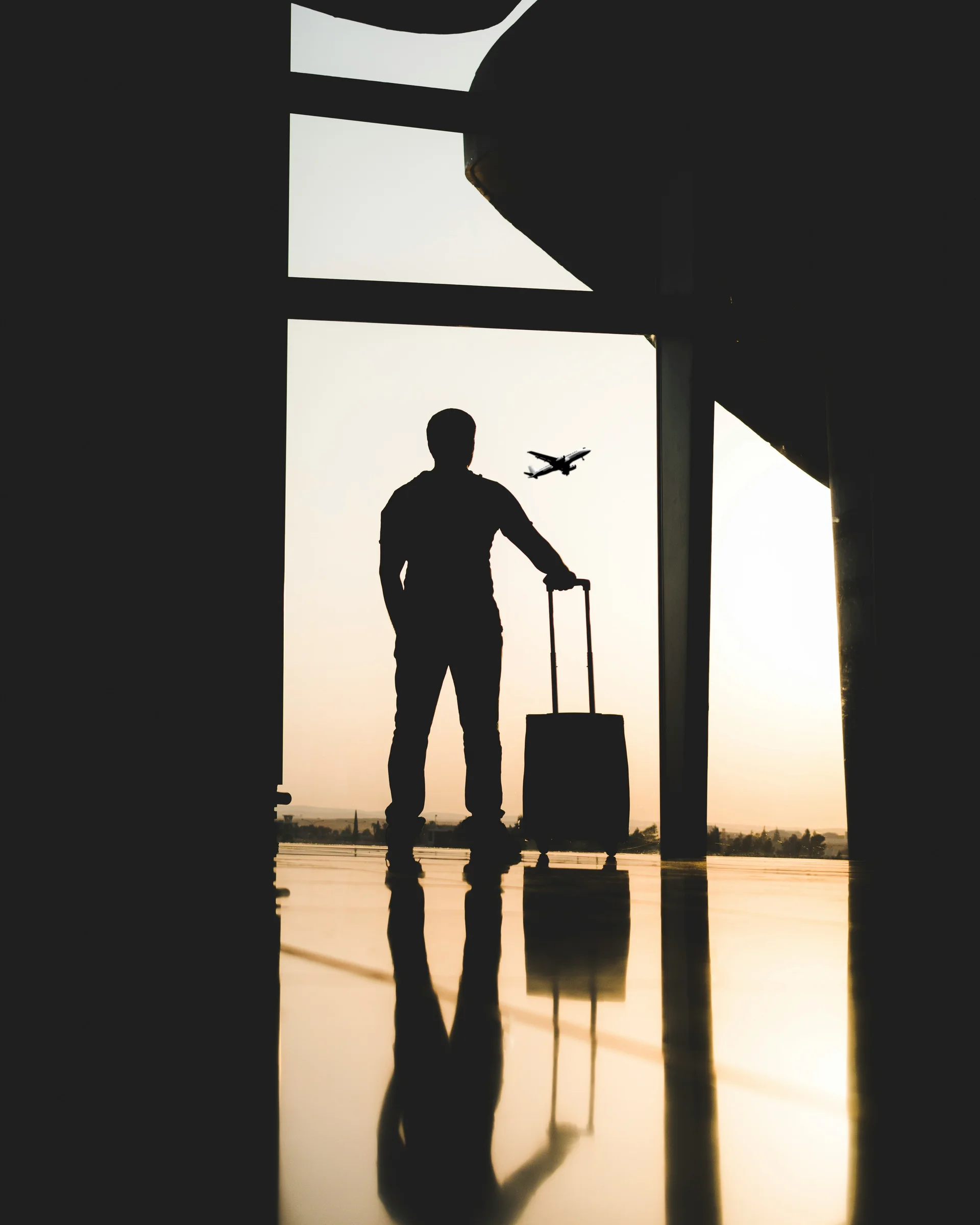 Man looking at airplane at airport