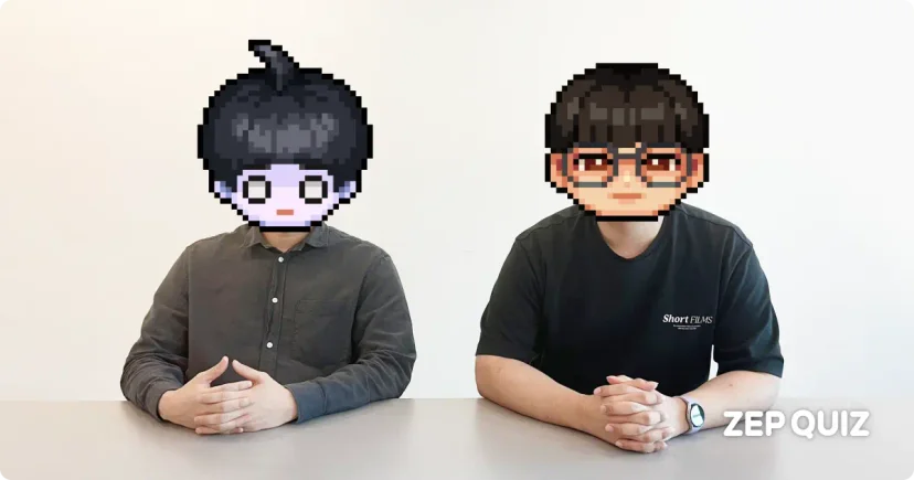 ZEP QUIZ developers featured in an interview, seated at a table with pixel art avatars covering their faces. One wears a button-up shirt, the other a 'Short FILMS' T-shirt. ZEP QUIZ logo shown in the corner.