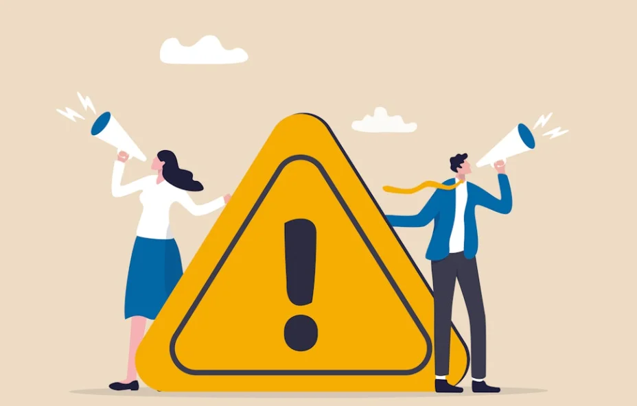 Two people with megaphones standing beside a warning sign with an exclamation mark, symbolizing important announcement
