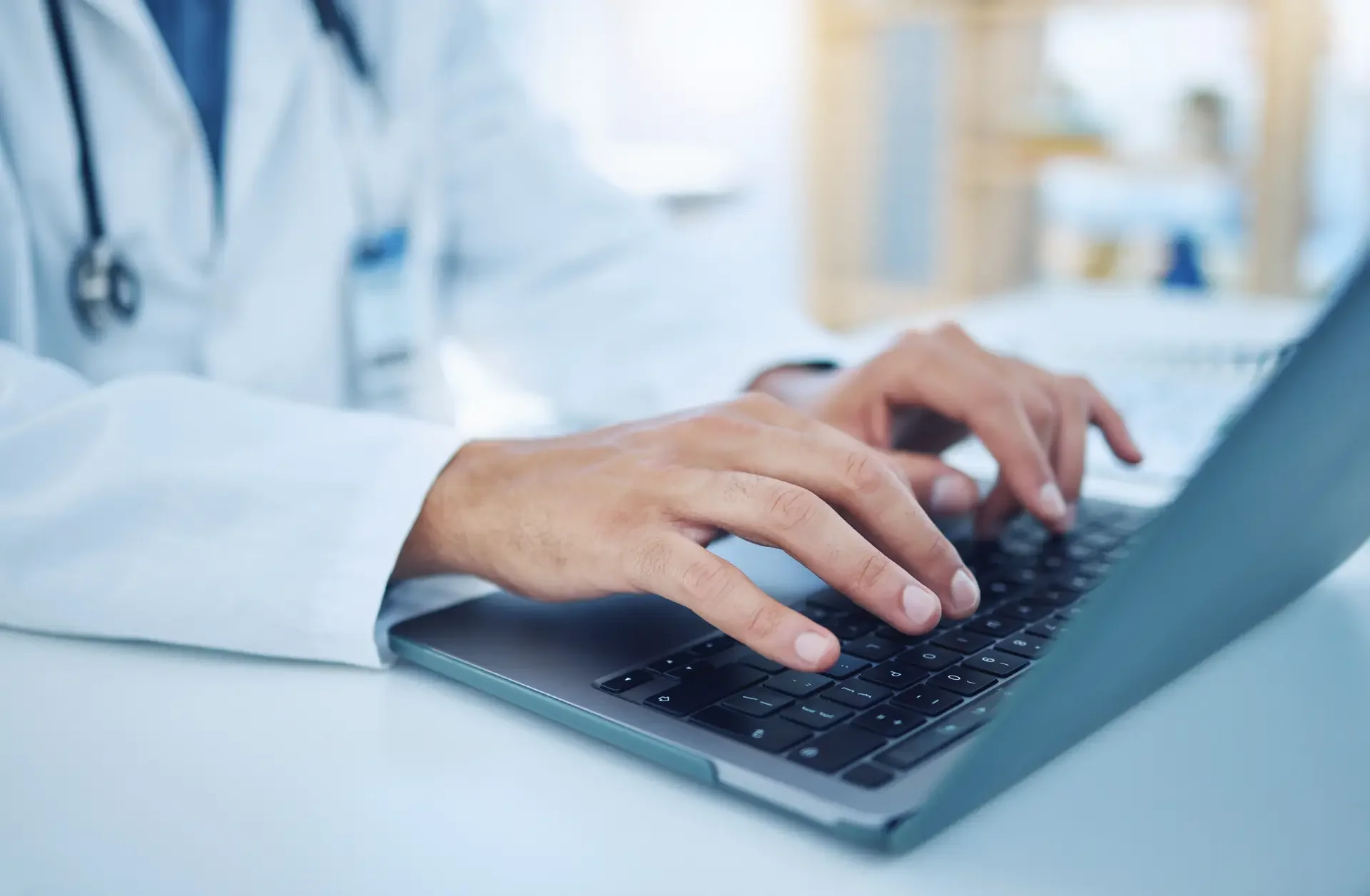 Clinicians use patient data on laptops to record and analyze trends—enabling early detection and preventive intervention.