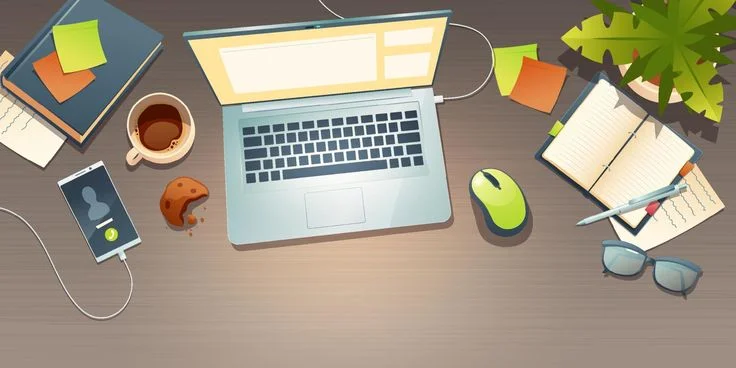 Top view of a modern office desk with laptop, coffee, notebook
