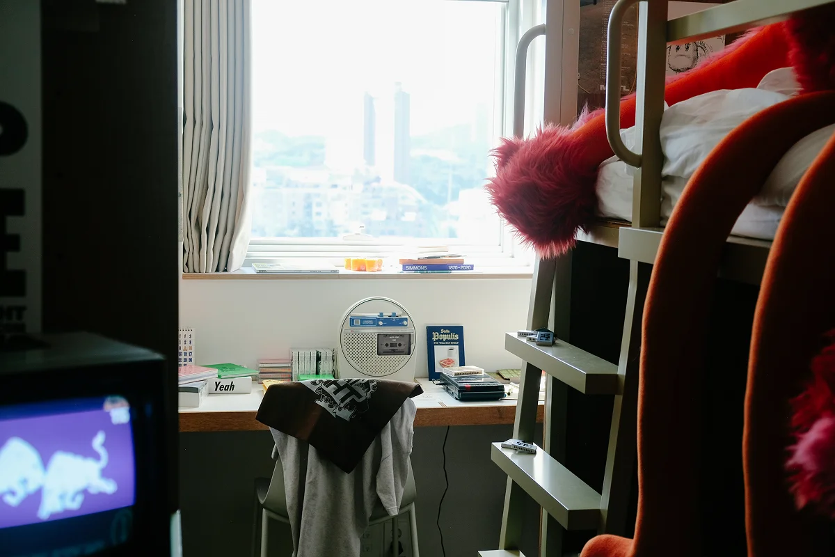 맹그로브 동대문 장기 숙박 Bunk 객실 전경 – 창가 책상과 의자가 있는 2층 침대 구조의 코리빙 공간으로, 도시 전망과 함께 장기 체류 고객이 업무와 휴식을 모두 누릴 수 있는 아늑한 객실.