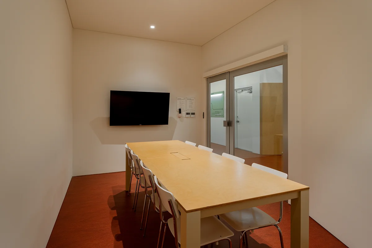 맹그로브 동대문 장기 숙박 멤버스라운지 회의실 – 대형 테이블과 의자, 모니터가 갖춰진 회의 공간으로 장기 체류 고객이 팀 미팅, 워크숍, 원격 근무까지 활용할 수 있는 코리빙 전용 업무 시설.