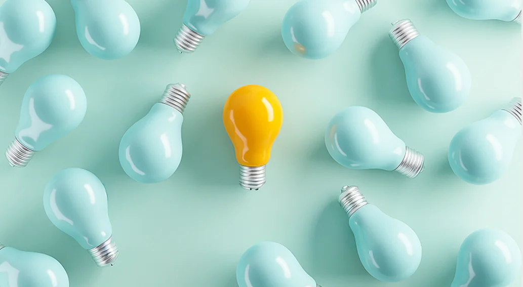 여러 개의 전구 중 하나만 노란색으로 빛나는 모습. 차별화된 프로필의 중요성을 상징하는 이미지