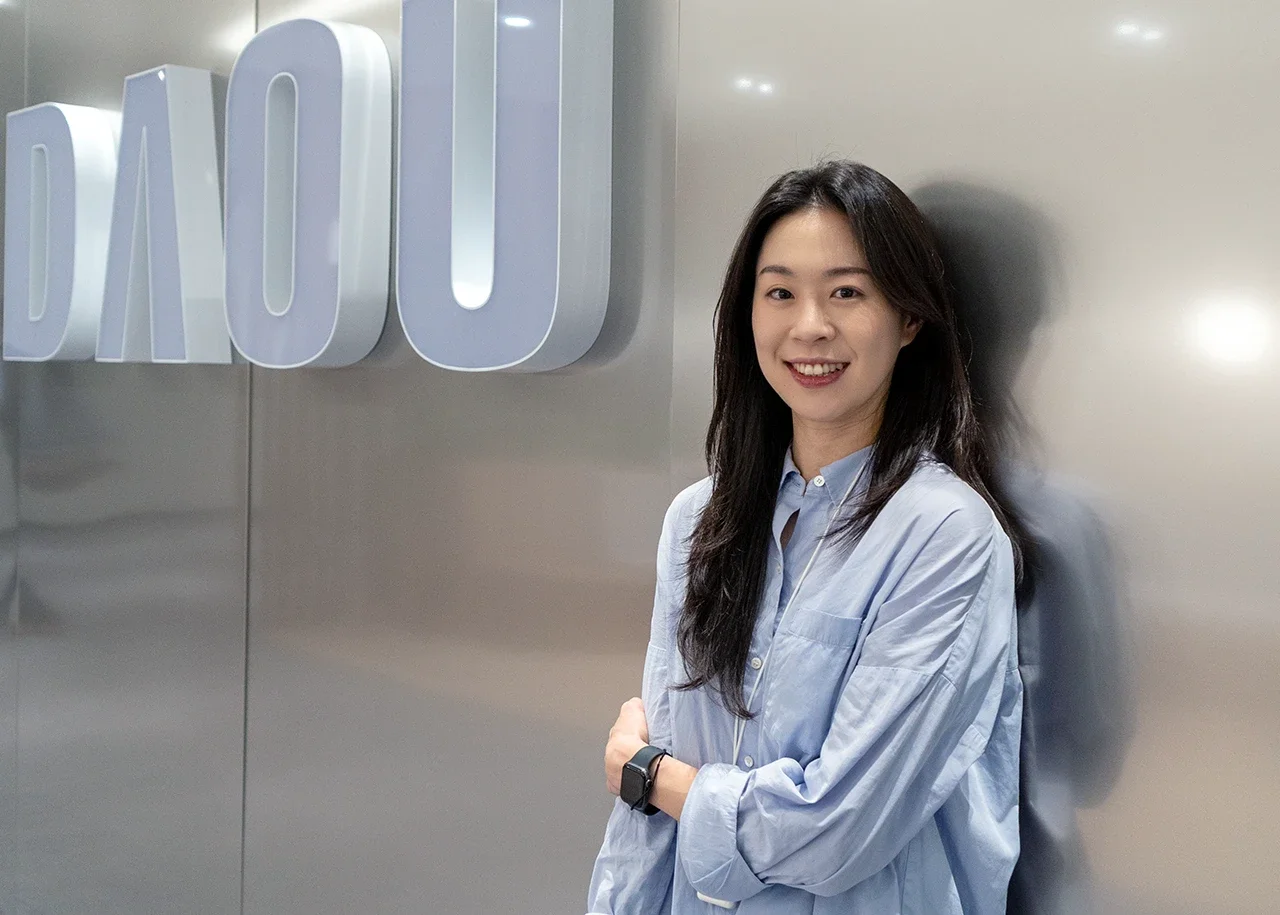 다우기술 현판 앞에서 활짝 웃고 있는 인사 담당자 김소영 선임