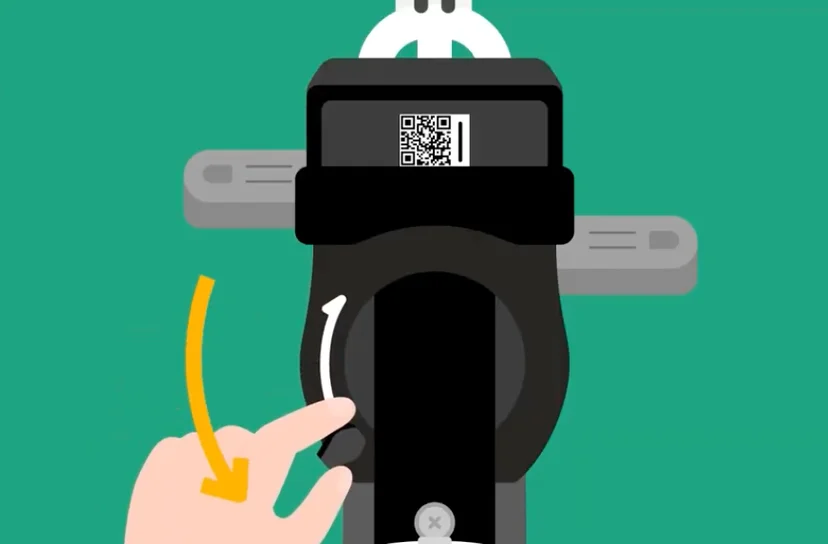 Close-up of a person manually pulling down the locking lever on the back wheel of a Ttareungyi bike.