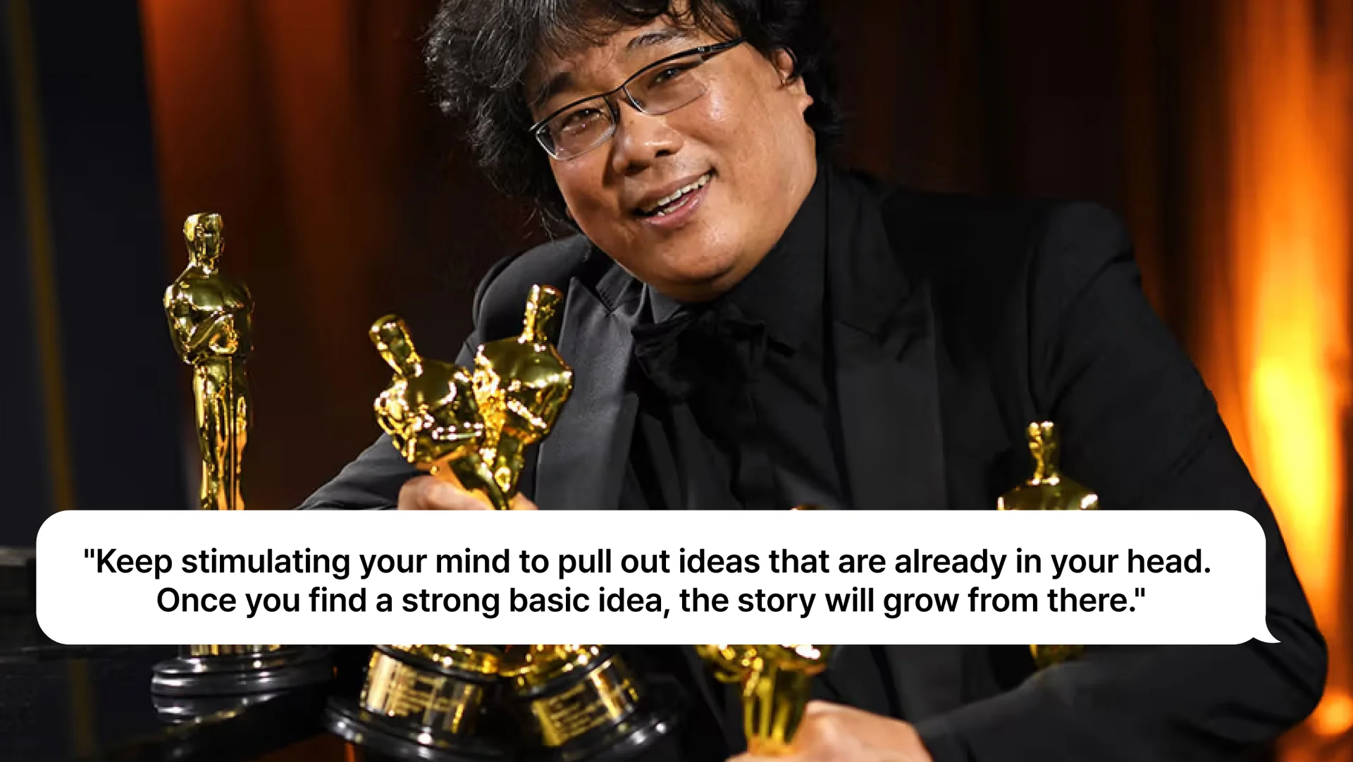 A man in a black suit holding multiple gold award statuettes, with a quote about developing ideas displayed over the image