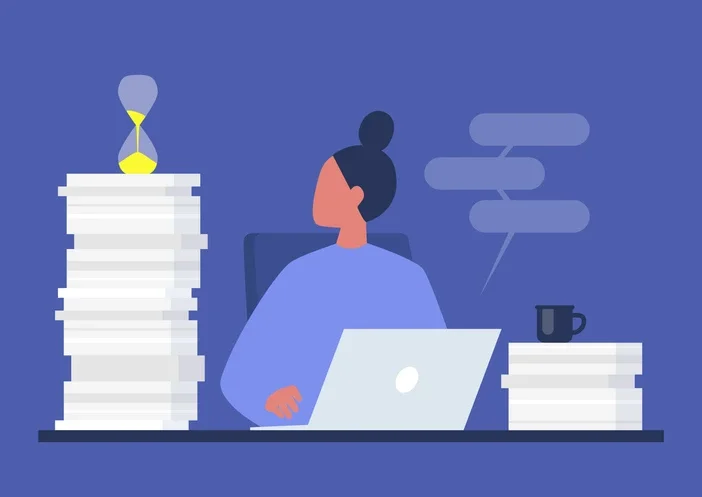 서류가 쌓인 책상에 앉아 랩탑으로 업무를 하고 있는 직장인 일러스트