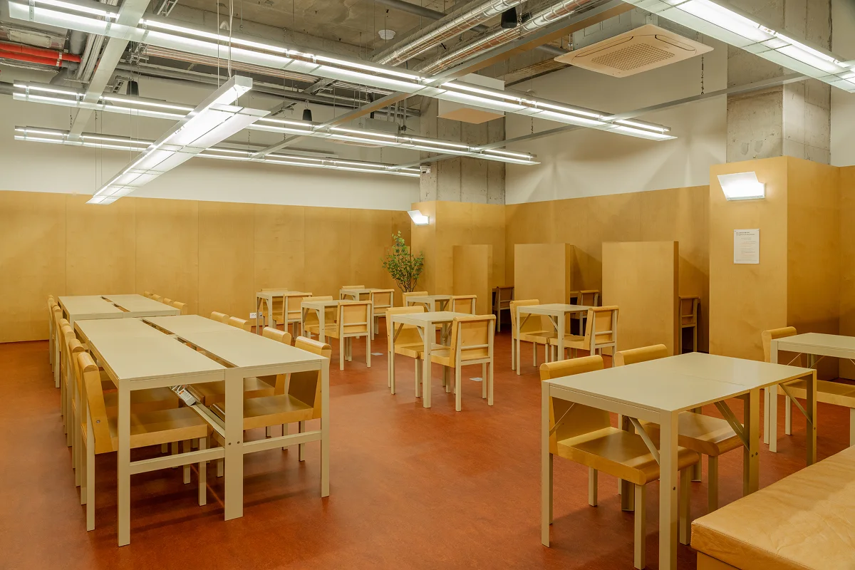 Mangrove dedicated study room — long wooden tables, individual seating, and bright overhead lighting designed for focused work and exam preparation. No need to pay for a study café.
