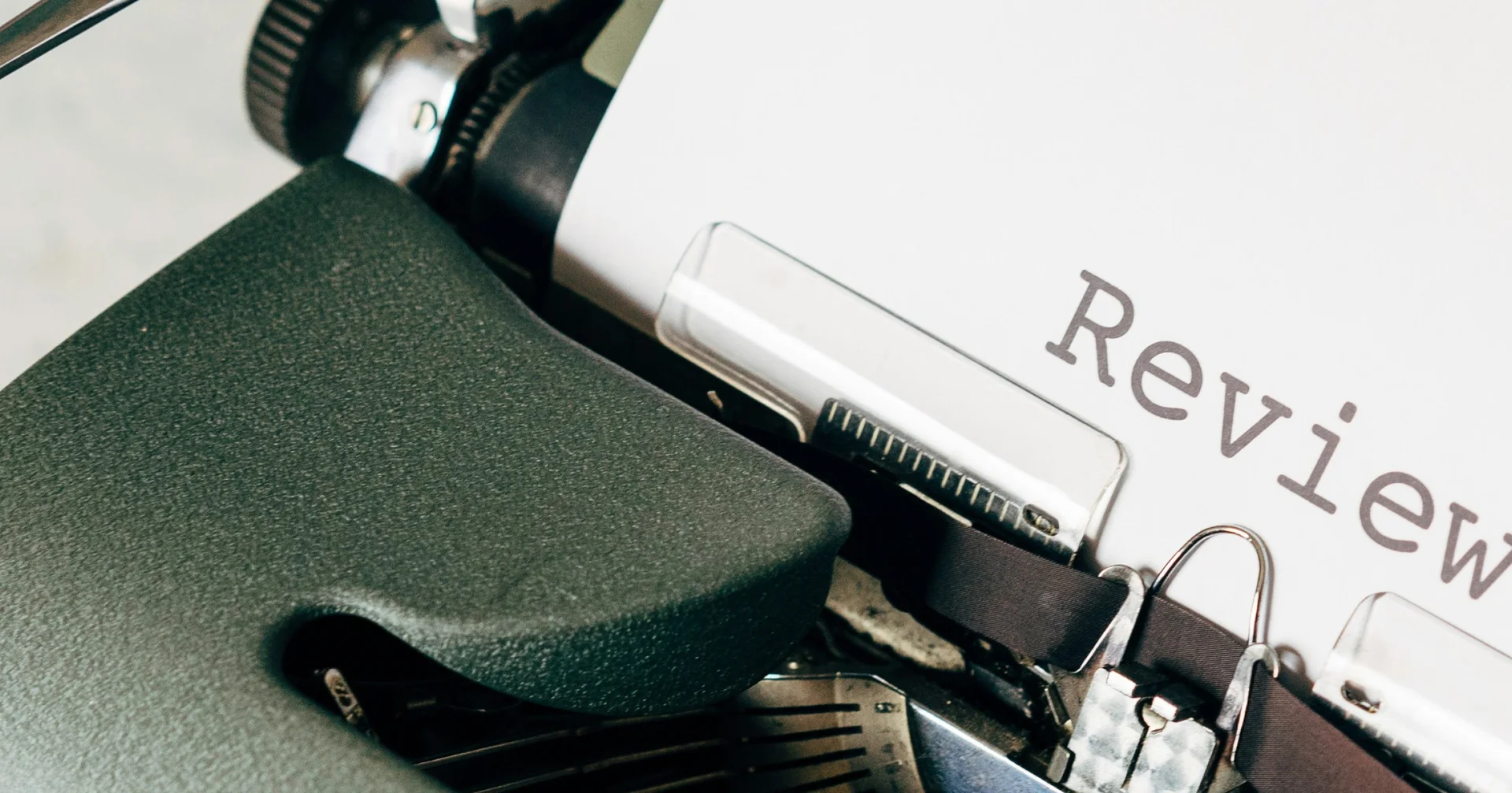 Close-up of vintage typewriter with "Review" text typed