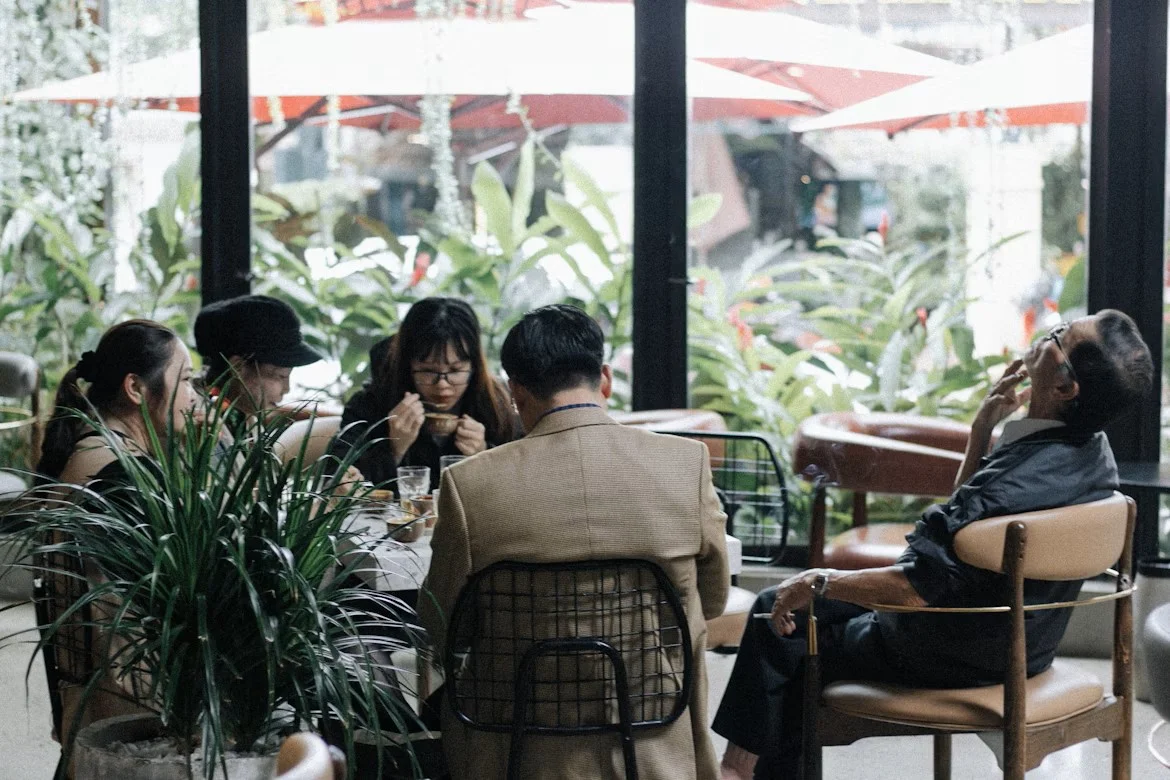 A group of people eating around a table.