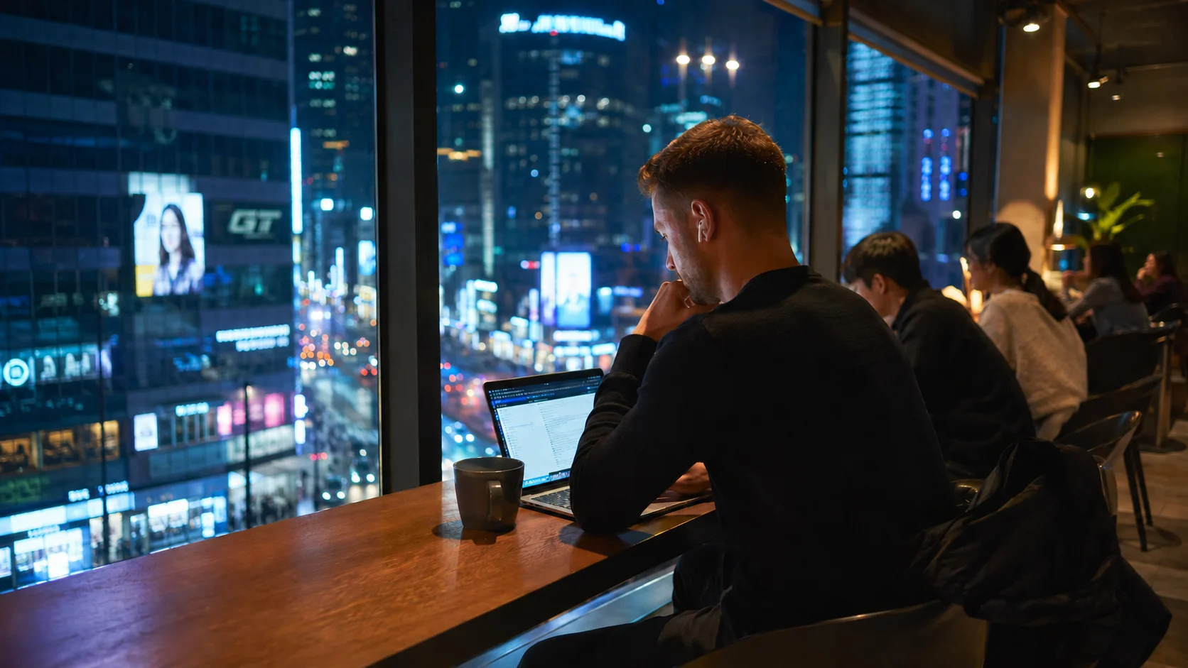 Digital nomad working late overlooking illuminated Seoul skyline