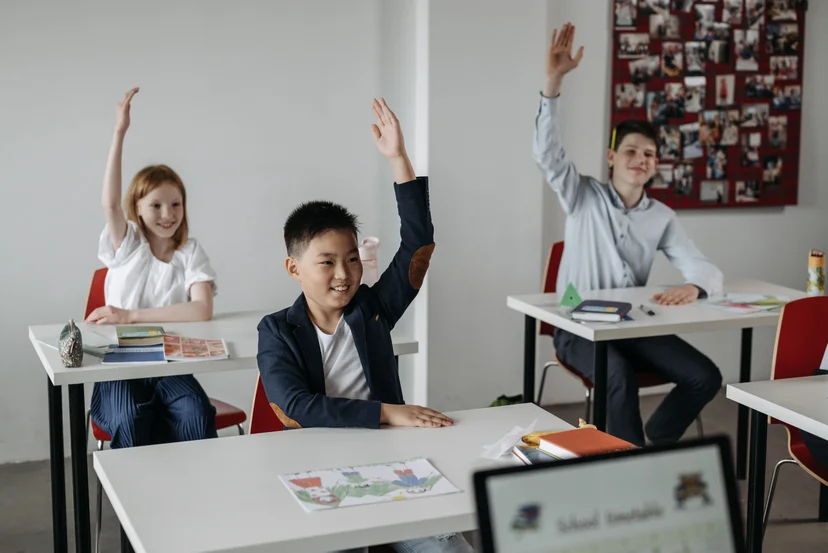 Students participate in a class discussion, showing active learning.