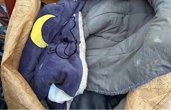 기부된 달님 곰인형 패턴의 보라색 헌 이불과 그레이 퀼팅 매트