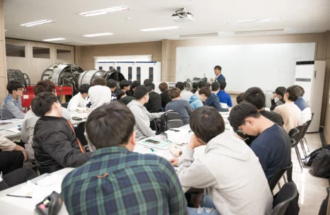교실에서 설명을 듣는 학생들