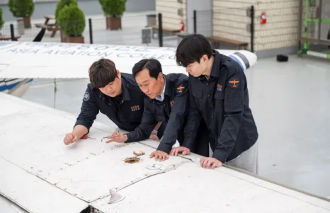 야외 실습에서 도면을 살펴보는 학생들