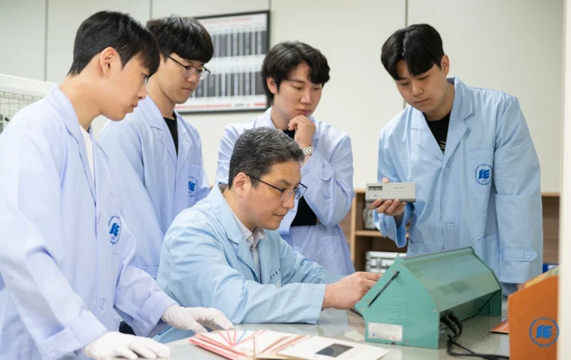 작업대에서 실습 장비를 다루는 학생들