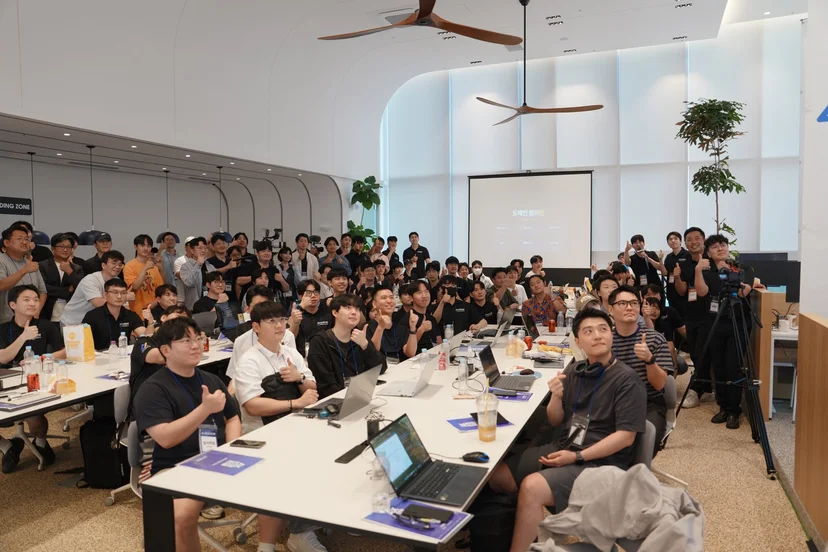 AI 채점 엔진의 바탕이 된 AX 인재전쟁 해커톤 본선 현장, 노트북을 펼친 참가자들의 단체 사진