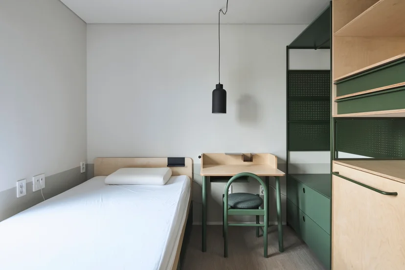 Single room with a bed, desk and storage at Mangrove Soongin