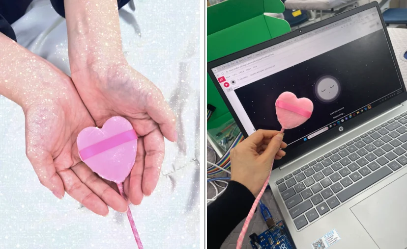 분홍 하트 모양으로 만든 장치와, 노트북 화면에 뜬 달 얼굴 애니메이션