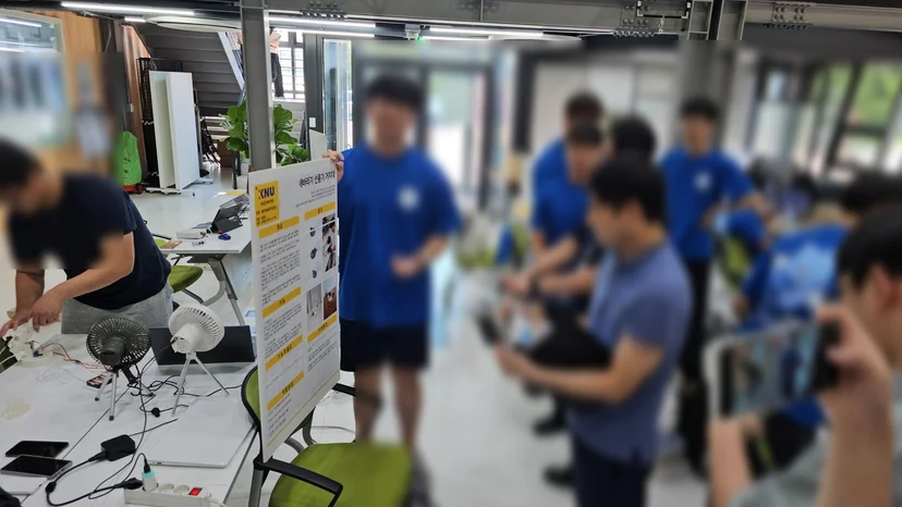 ‘해바라기 선풍기 거치대’ 발표 판 앞에서 설명하는 학생과 선풍기 시연