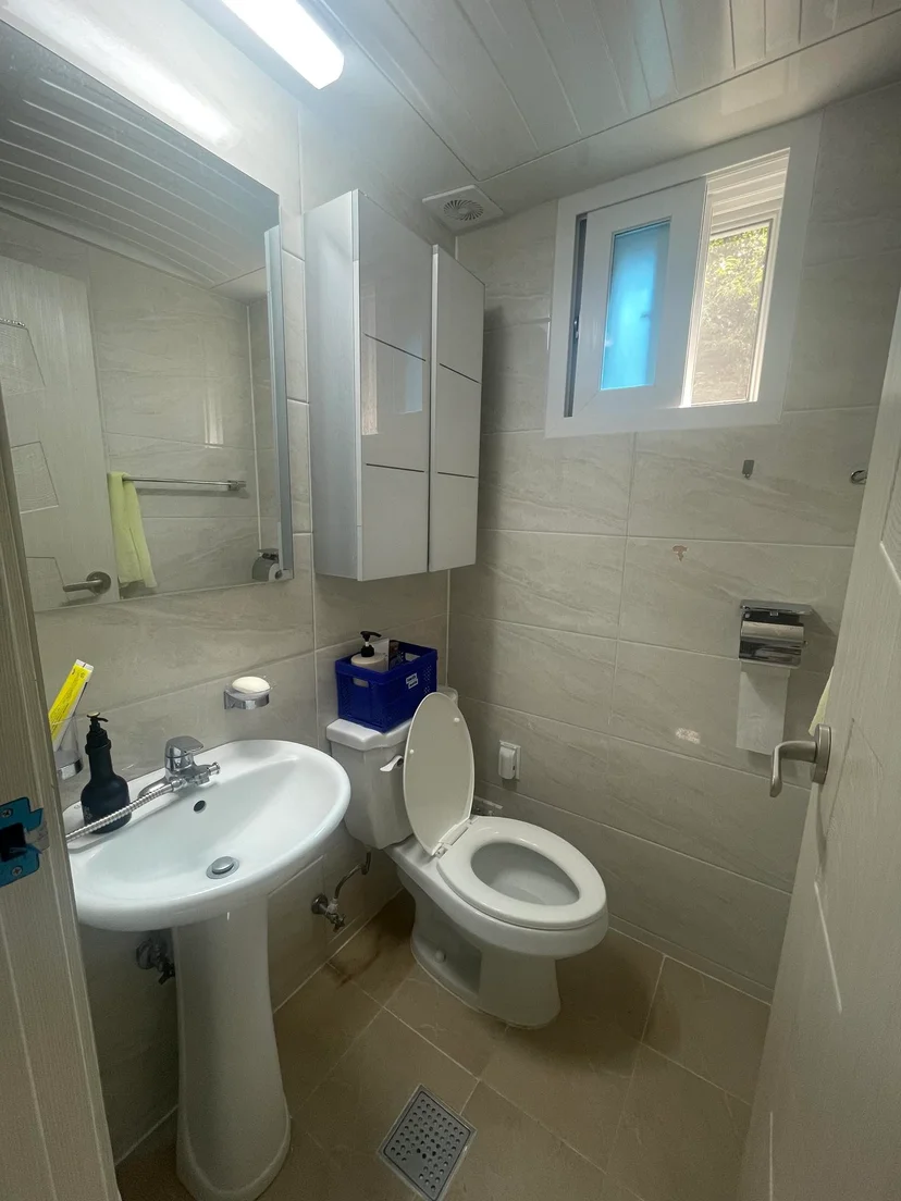 Private bathroom with a pedestal sink, mirror cabinet, tiled walls and a window (Listing ID : 17562)