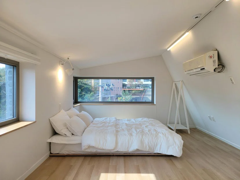 Loft bedroom with a queen bed under a sloped ceiling (Listing ID : 17400)