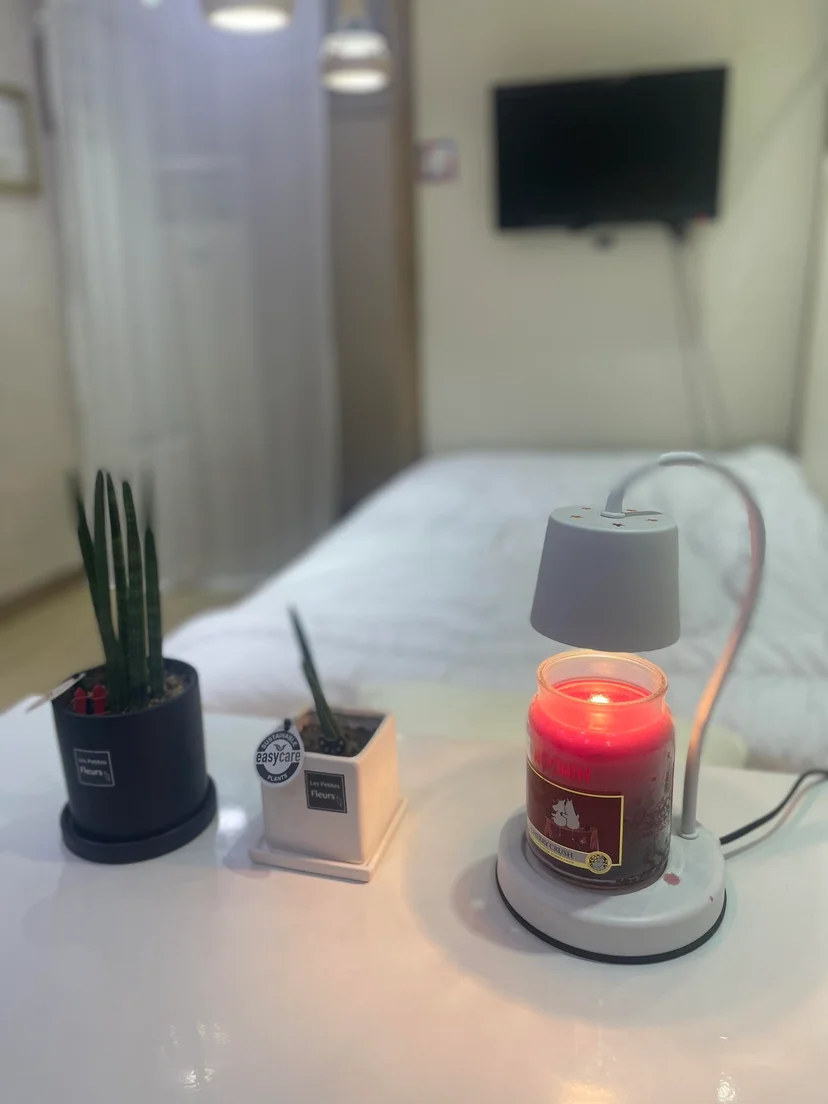 Bedside table with plants next to the bed (Listing ID : 12332)