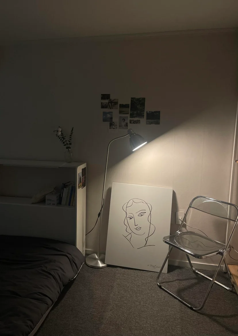 Cozy bedroom corner with a floor lamp and a line-art poster (Listing ID : 22604)