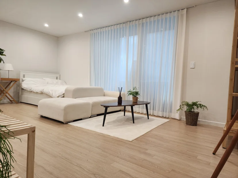 Living area with a bed and sofa by the window (Listing ID : 33665)
