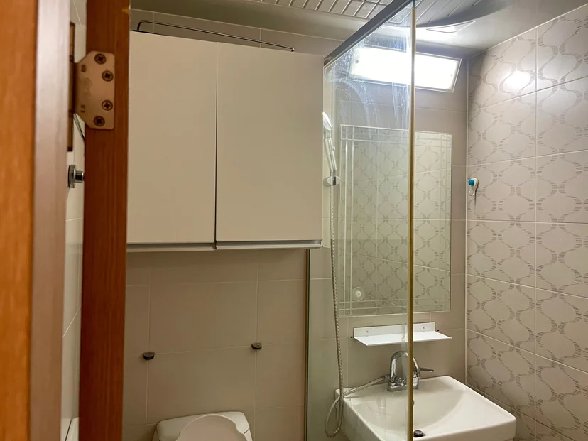Bathroom with a glass-partition shower and wall sink (Listing ID : 33622)