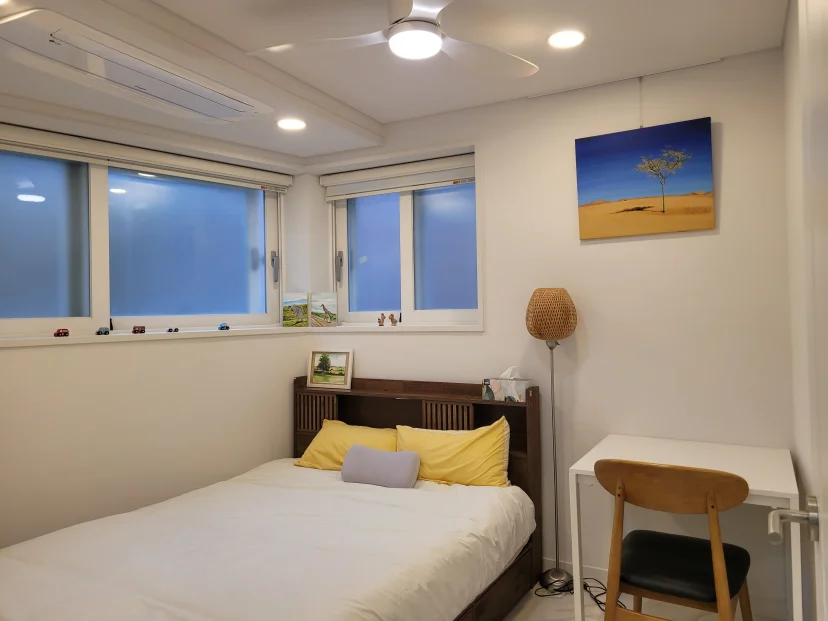 Bedroom with a large bed, a desk, and framed wall art (Listing ID : 41157)