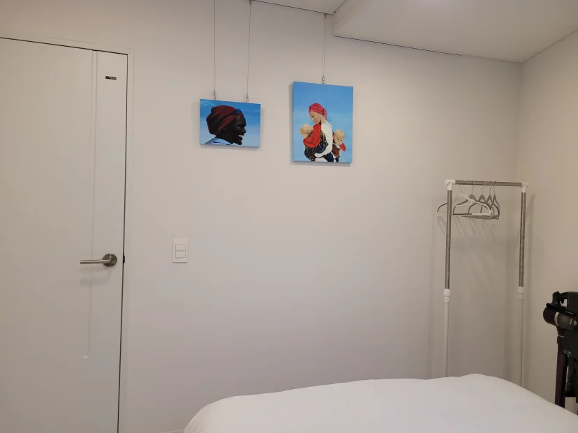 Bedroom corner with a clothing rack and wall art (Listing ID : 41157)