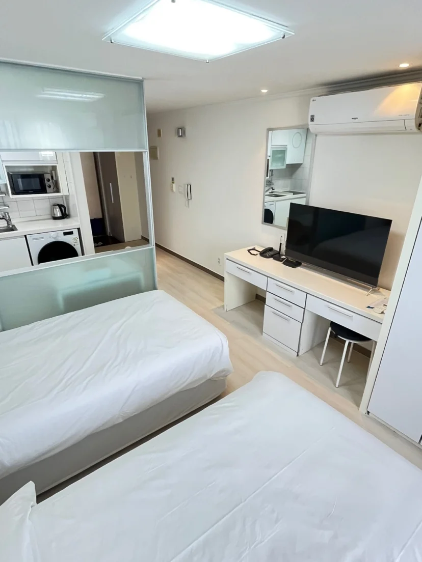 Studio apartment with twin beds, desk with TV, and kitchenette (Listing ID : 34007)