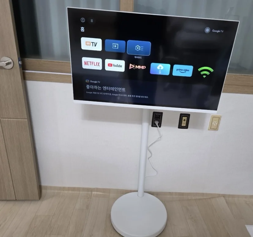 Smart TV on a stand showing the Google TV home screen (Listing ID : 46995)