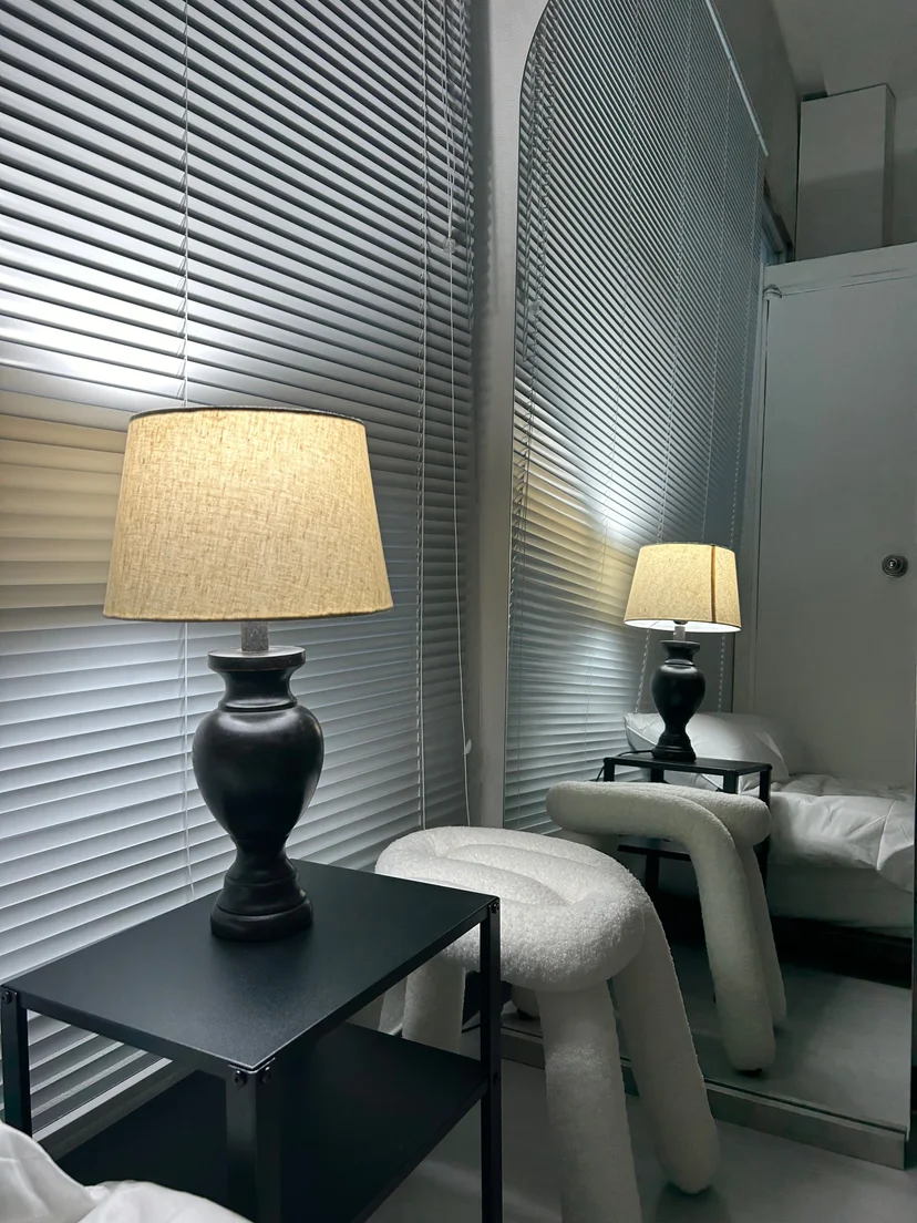 Bedside lamp and stool with a mirror and closet nearby (Listing ID : 30632)