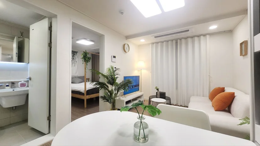 Bright living room with a sofa and dining nook (Listing ID : 40239)