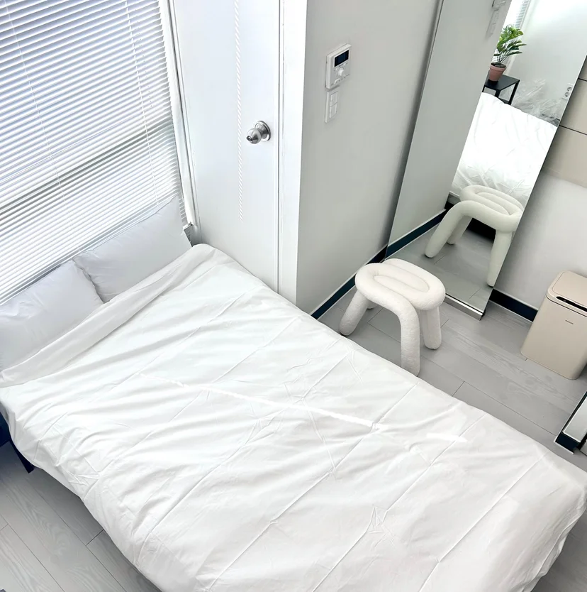Overhead view of the bed with an air purifier and a small stool (Listing ID : 30632)