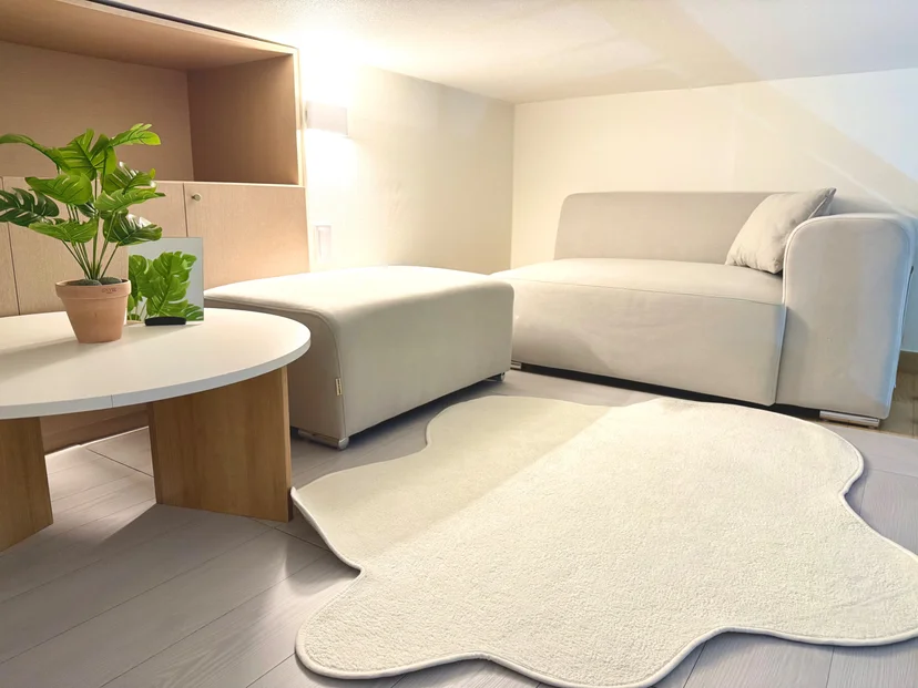 Living area with a beige sectional sofa and a round coffee table (Listing ID : 30632)
