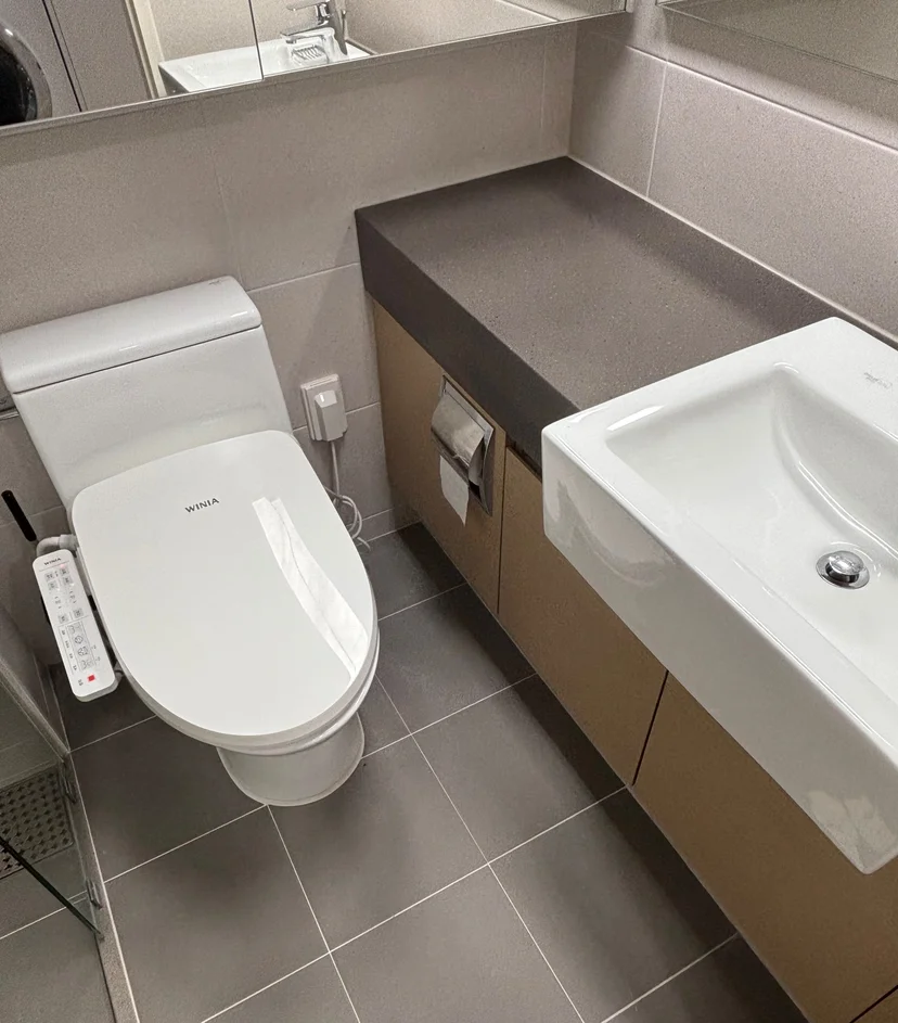 Hotel-style bathroom with vanity sink and grey tiles (Listing ID : 30036)
