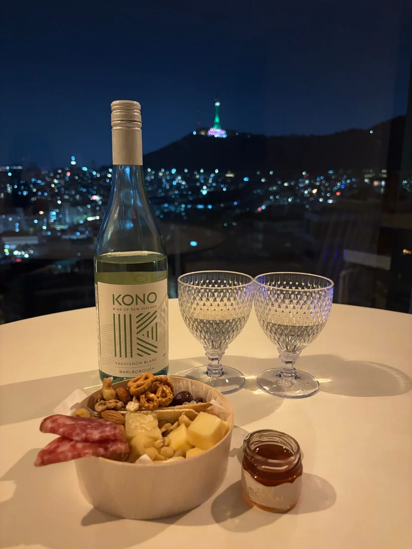 Night view of N Seoul Tower with wine and charcuterie board by window (Listing ID : 43593)