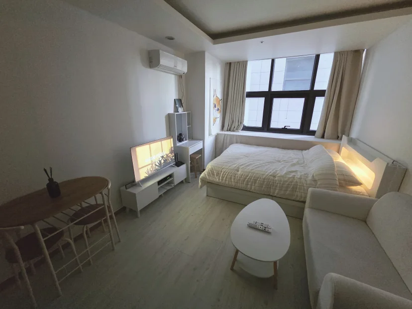 Studio room with bed, sofa, and sunlit windows (Listing ID : 44317)