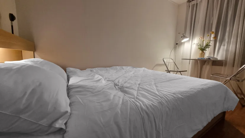 Double bed with white bedding and a wooden headboard (Listing ID : 15851)